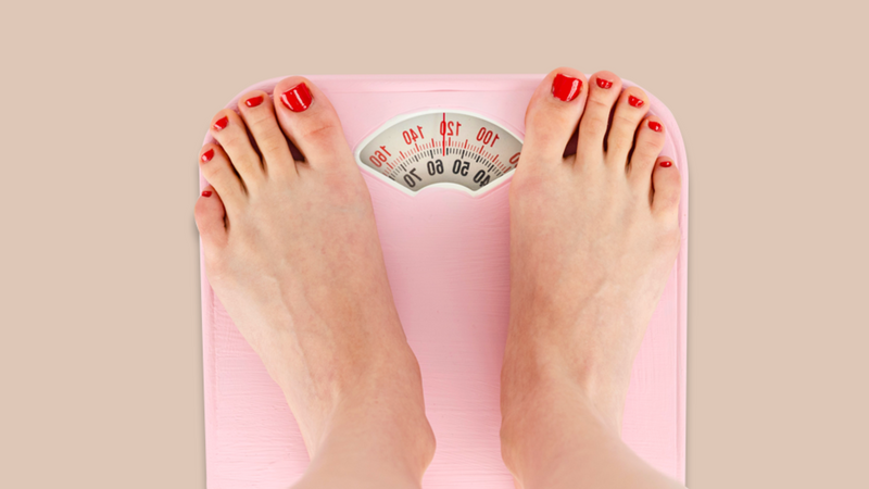 Image of feet on scales, measuring weight